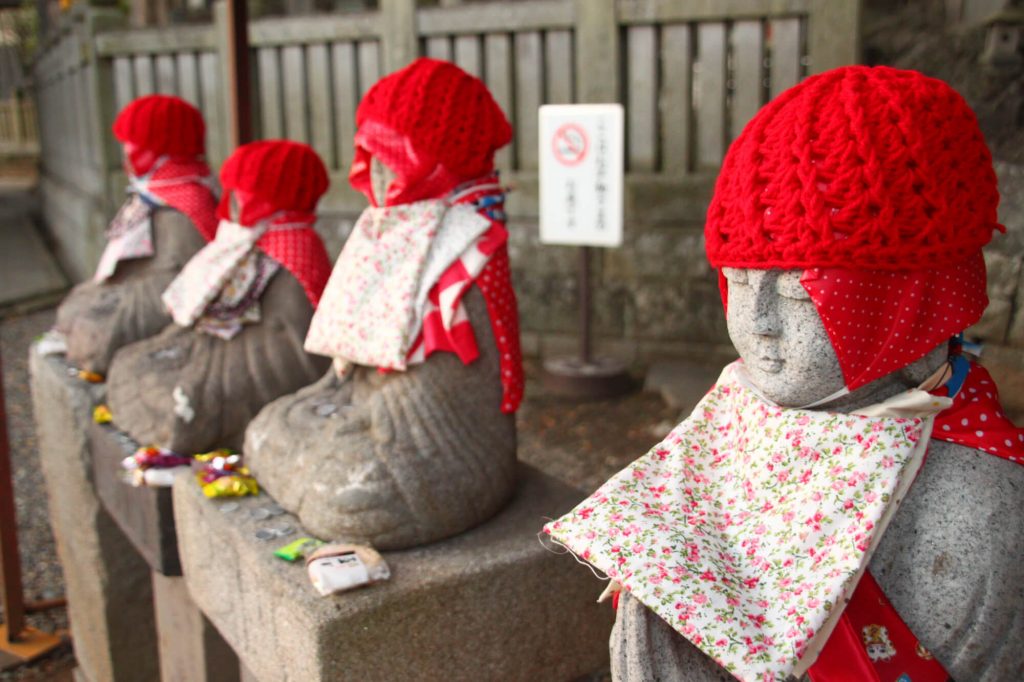 Small statues with hats at Narita san Shinsho-ji